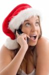 Woman Wearing Christmas Hat And Talking On Cell Phone Stock Photo