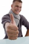 Smiling Young Man Showing Thumb Up Stock Photo