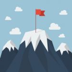 Red Flag On A Mountain Peak Stock Photo