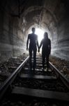 Couple Walking Together Through A Railway Tunnel Stock Photo