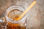 Glass Of Cola With Ice On Wooden Table Stock Photo