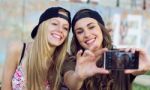 Beautiful Young Women Using Mobile Phone In The Street Stock Photo