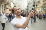 male Photographer With Smartphone Stock Photo