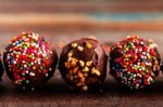 Chocolate Ball On A Wooden Stock Photo