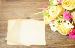 Paper Sheets And Invent Flowers On Wooden Table Stock Photo