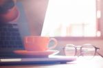 Coffee Cup With Keyboard On Wooden Table Stock Photo