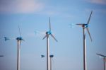 Green Renewable Energy Concept - Wind Generator Turbines In Sky Stock Photo