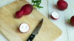 Many Radishes With Knife On The Chopping Board Stock Photo