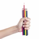 Colored Pencils In A Female Hand On A White Background  Stock Photo