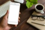 Close Up Hand Holding Phone Over Work Table, Mockup Phone Blank Stock Photo