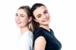 Happy Teen Girls Standing Back To Back Stock Photo