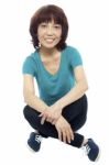 Asian Woman Sitting On Floor Stock Photo