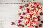 Still Life With Pomegranate , Cherry And Spices On The White Wooden Table Stock Photo