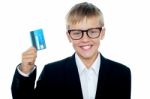 Young Boy Holding Credit Card Stock Photo