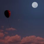 Red Balloon Floating At Night Stock Photo