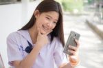 Portrait Of Thai Student Teen Beautiful Girl Using Her Smart Phone Selfie In School Stock Photo