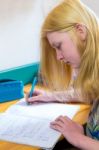 Blonde Schoolgirl Making Homework Stock Photo