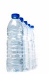 Row Of Plastic Water Bottles Isolated On A White Background Stock Photo