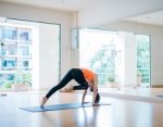 Asian Woman Doing Yoga Indoors Stock Photo