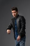 Casual Young Man In Black Leather Jacket And Denim Jeans Stock Photo