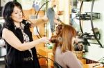 Hairdresser Drying Customer's Hair Stock Photo