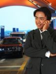 Businessman Waiting For A Taxi At The Airport Stock Photo