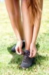 Girl Tying Her Shoes Stock Photo