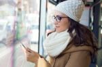 Young Beautiful Woman Using Her Mobile Phone On A  Bus Stock Photo