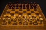 Light And Dark Wooden Chess Pieces On Chess Table Stock Photo