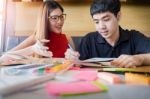 Student Couple Doing Homework With Laptop At Home Stock Photo