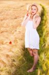 Lonely Beautiful Young Blonde Girl In White Dress With Straw Hat Stock Photo