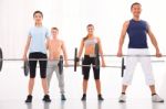 Multiethnic Group Of People Exercising With Weightlifting Bar In Stock Photo