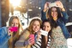 A Group Of Friends Taking Photos With A Smartphone Stock Photo