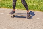 Young Woman Skateboarding In The Park Stock Photo