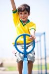 Young Kid Enjoying Swing Ride Stock Photo