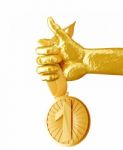 Gold Hand Holding Medal Isolated On White Background Stock Photo