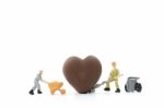 Miniature Worker Making Heart Shaped Chocolate On White Background , Stock Photo