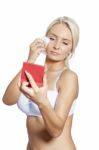 Young Woman Clean Face With Wet Wipes, Looking On Mirror In Hand Stock Photo