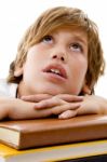 Close View Of Boy With Books And Looking Up Stock Photo