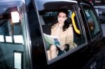 Female Passenger Reading Newspaper Inside Taxi Stock Photo