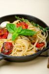 Spaghetti Pasta With Baked Cherry Tomatoes And Basil Stock Photo