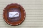 Japanese Traditional Dessert In White Paper Wrap With Red Rope Stock Photo