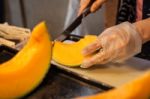 Cutting Japanese Melon Stock Photo