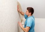 Young Worker Smoothing Wallpaper Stock Photo