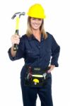 Female Construction Worker Holding Up Hammer Stock Photo