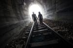 Couple Walking Together Through A Railway Tunnel Stock Photo