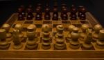 Light And Dark Wooden Chess Pieces On Chess Table Stock Photo