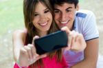 Couple Taking Photo Of Themselves With Smart Phone On Romantic P Stock Photo