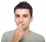 Young Man Applying Lip Balm Stock Photo