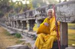 An Unidentified Old Buddhist Female Monk Dressed In Orange Toga Stock Photo